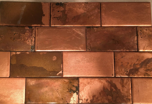 A set of copper ceramic tiles with a reddish-brown hue and a matte finish.